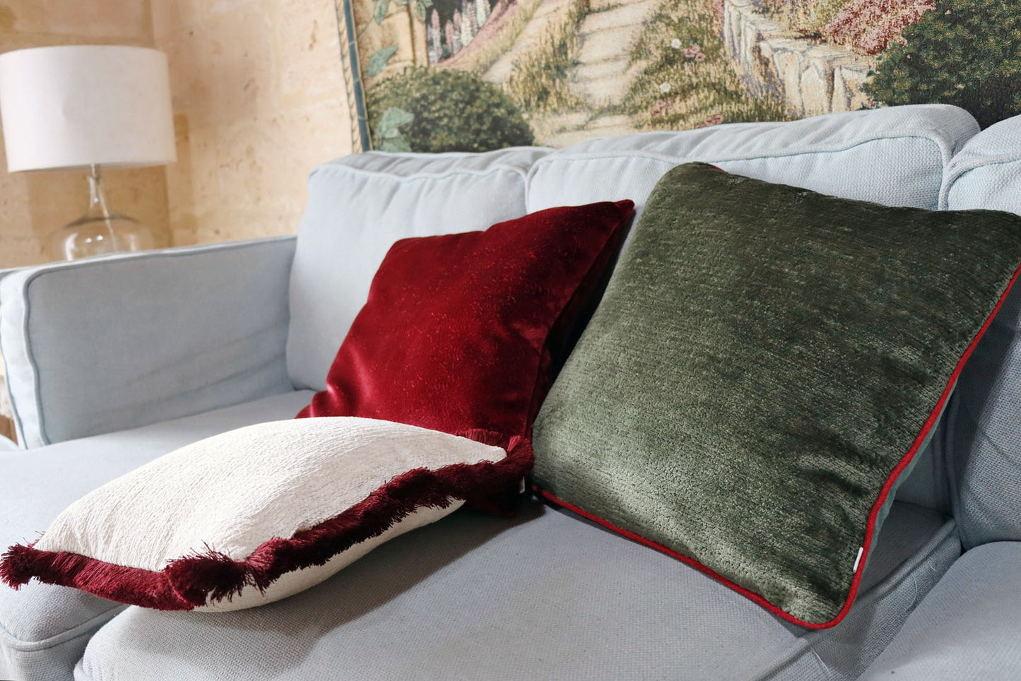 Gray sofa with chenille cushion cover with contrasting piping on a neutral background