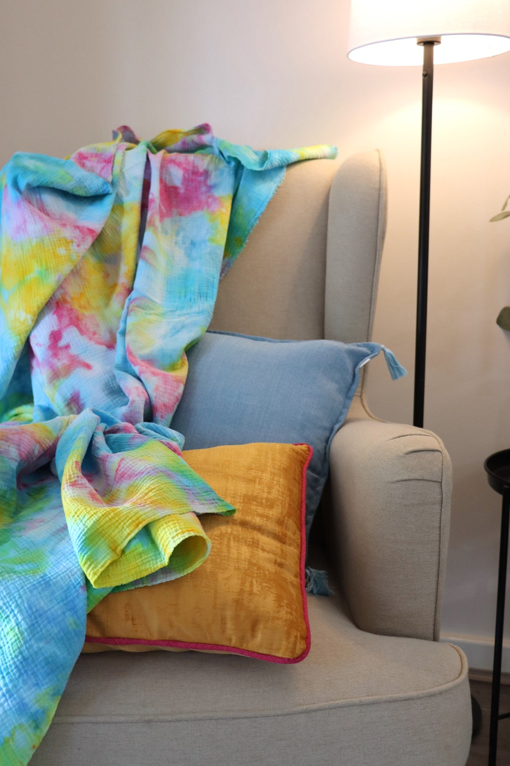 Photo of ice-dyed cotton throw on chair