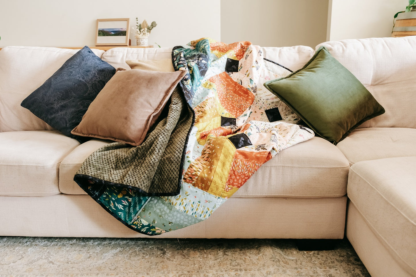 Lifestyle photo of velvet cushion cover with flange edging on couch