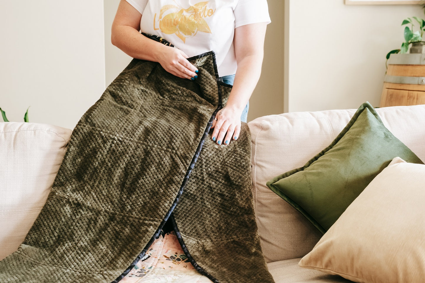 Lifestyle photo of textured velvet cushion cover on couch