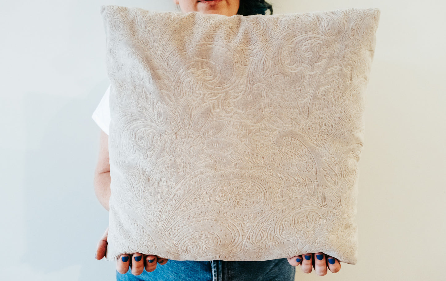 Close up of paisley textured velvet cushion cover