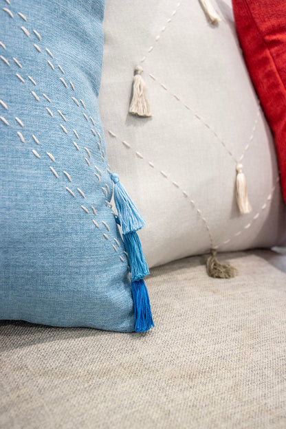 Close up of handmade tassels from  cushion cover with embroidery and tassels