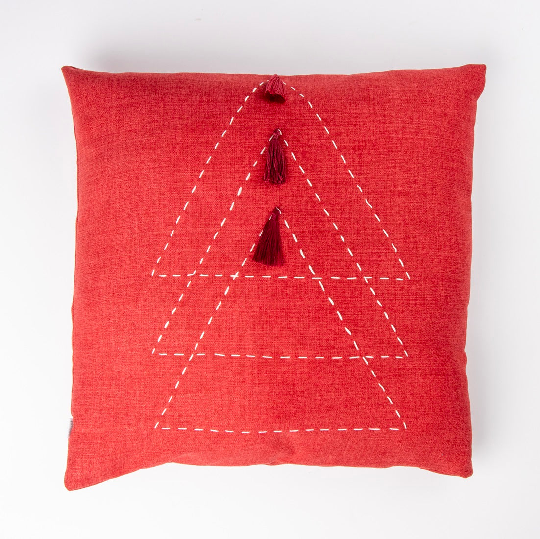 Front of red triangle cushion cover with embroidery and tassels