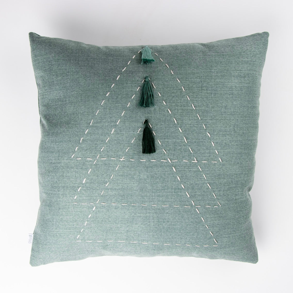 Front of sage green cushion cover with embroidery and tassels