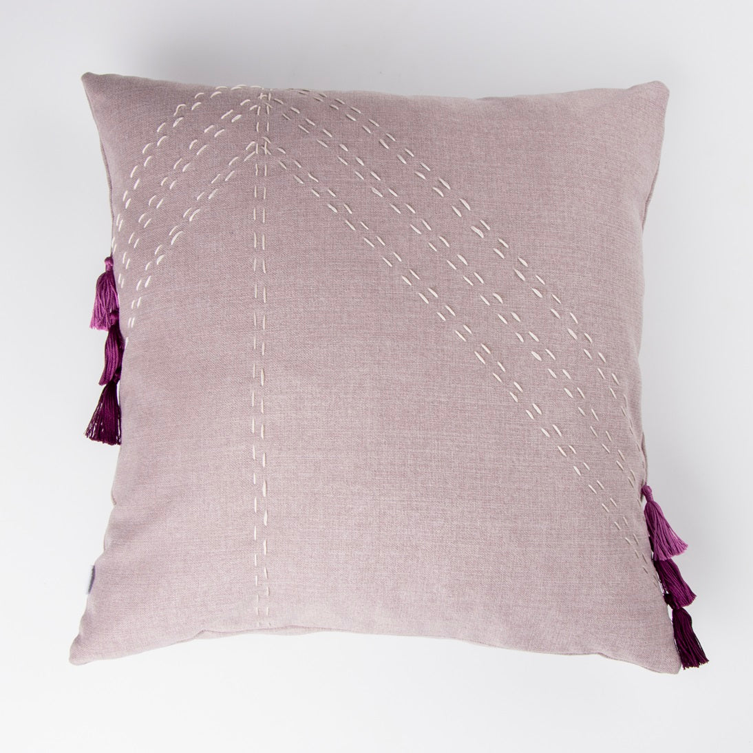 Front of light purple textured cushion cover with embroidery and tassels