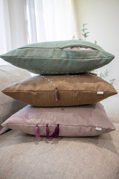 Stack of handmade cushion cover with embroidery and tassels