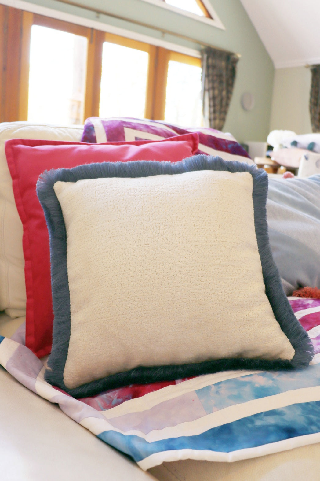 Decorative chenille cushion cover with cotton fringe with a colourful quilt