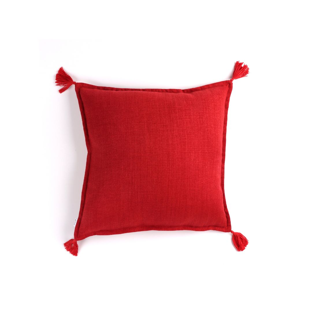 Front of red handmade cushion cover with tassels