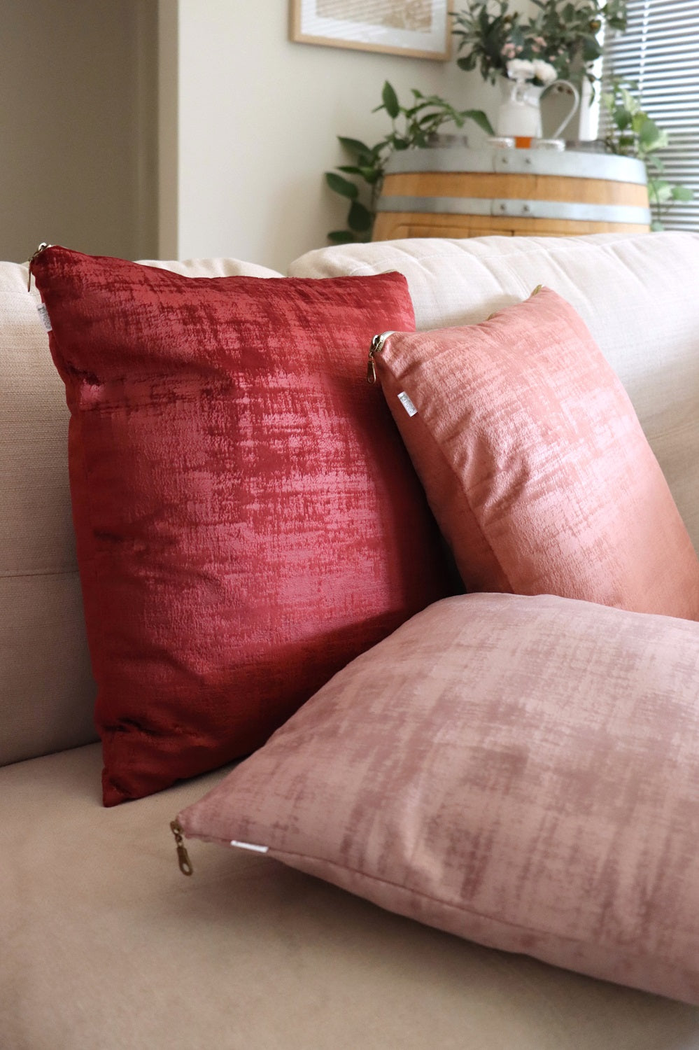 Lifestyle photo of red and pink handmade textured velvet cushion cover with exposed zipper