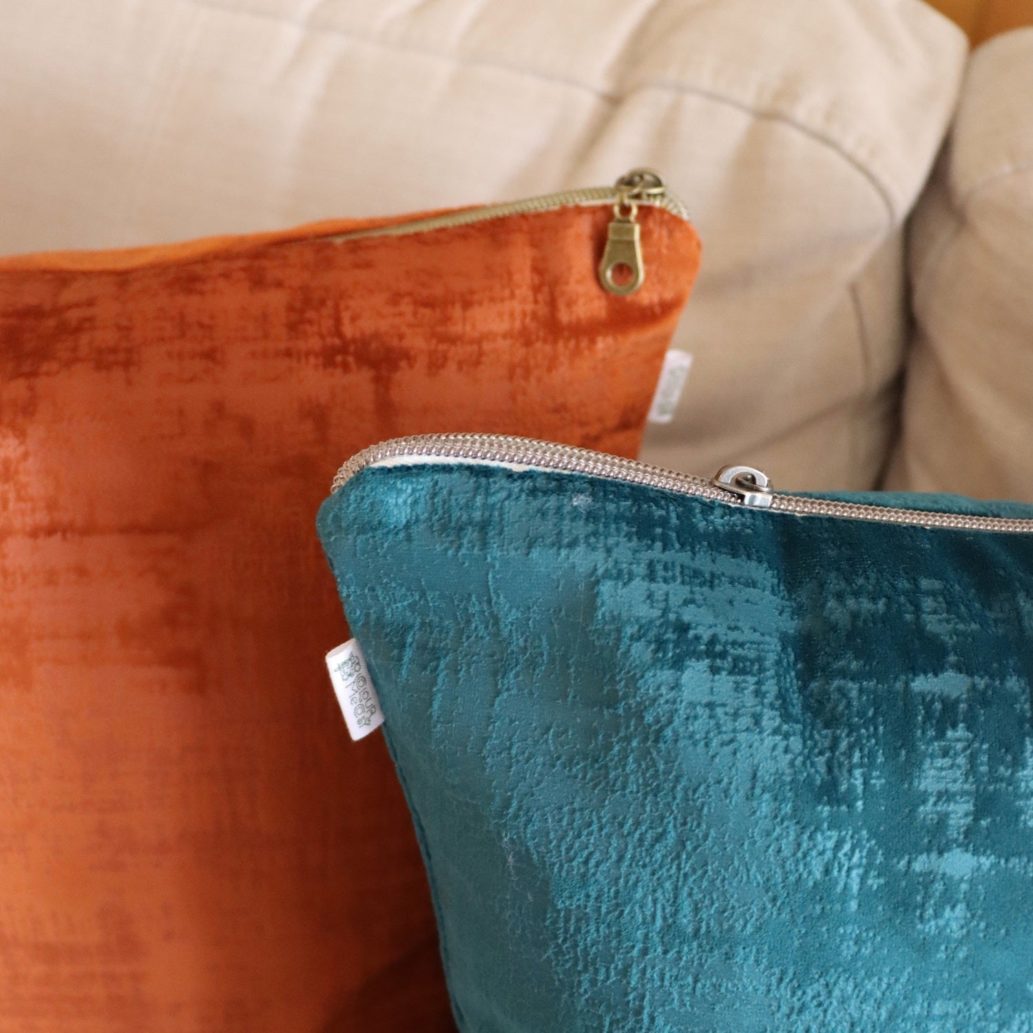 Close up of textured velvet cushion cover with exposed zipper on sofa