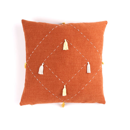 Front of orange diamond handmade cushion cover with embroidery and tassels