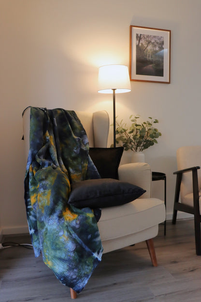 Lifestyle photo of handmade ice-dyed cotton throw