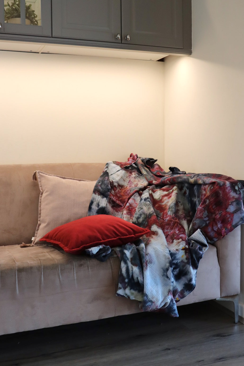 Lifestyle photo of handmade ice-dyed cotton throw on couch