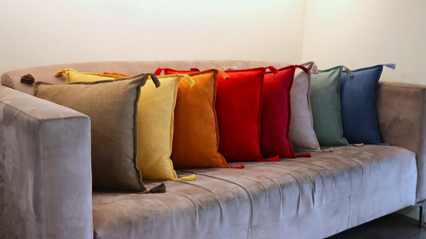 Group of handmade cushion cover with tassels on sofa