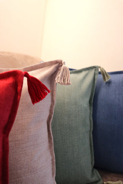 Group of handmade cushion cover with tassels on sofa