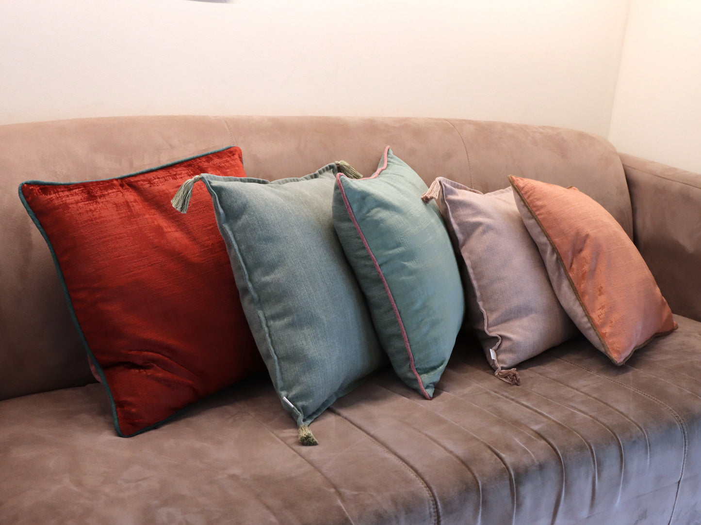 Group of handmade cushion cover with tassels on sofa