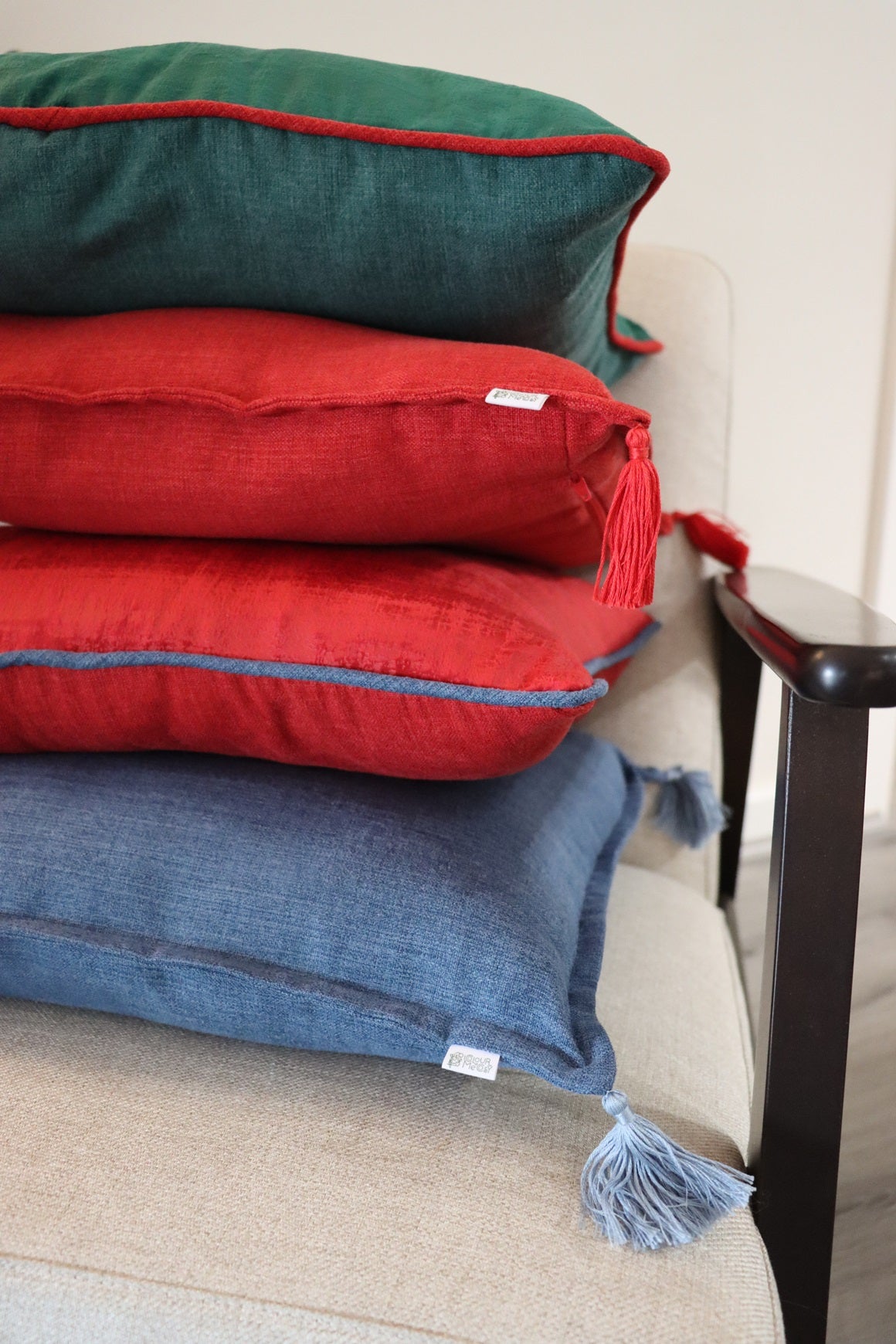 Stack of handmade cushion cover with tassels on chair