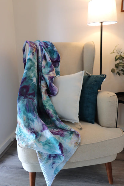 Lifestyle photo of purple and blue ice-dyed cotton throw