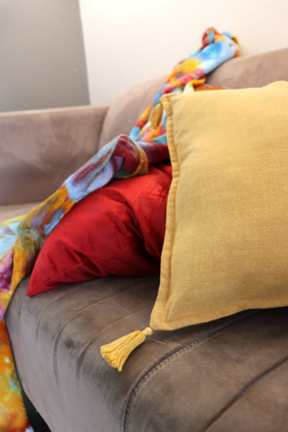 Lifestyle photo of Handmade cushion cover with tassels on couch