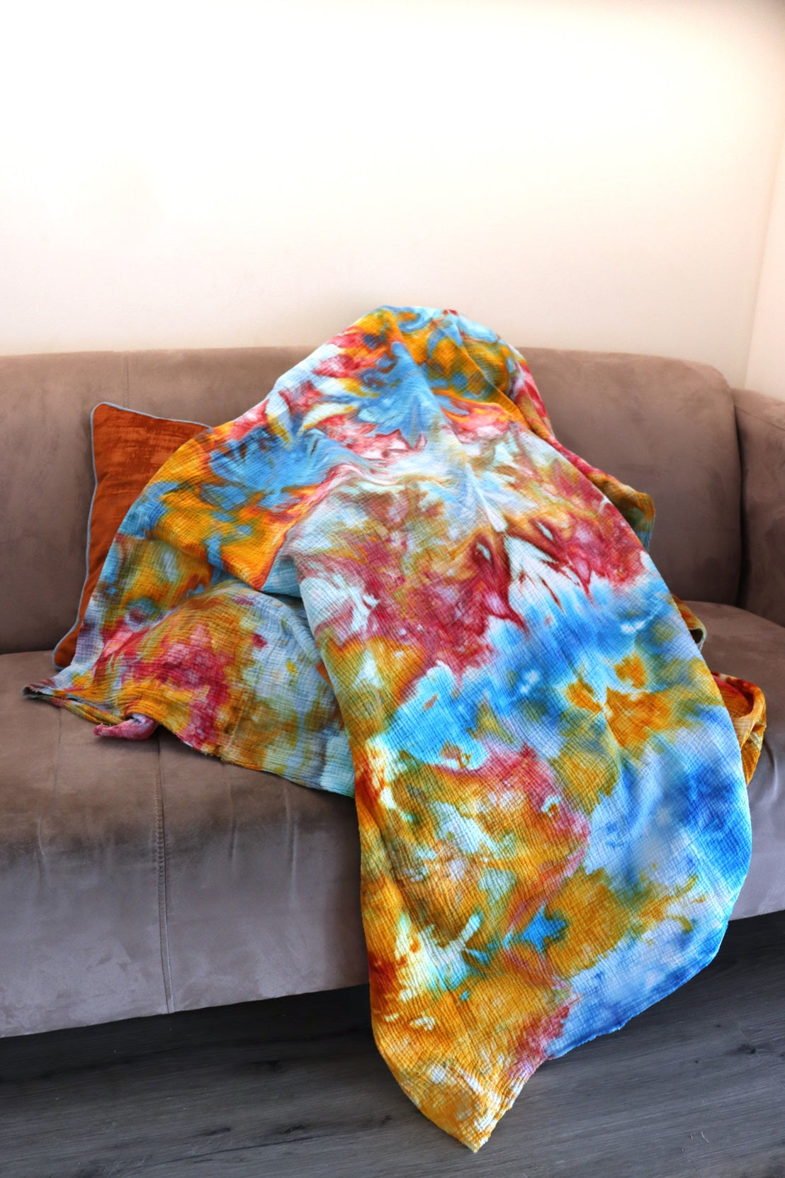 Lifestyle photo of handmade ice-dyed cotton throw