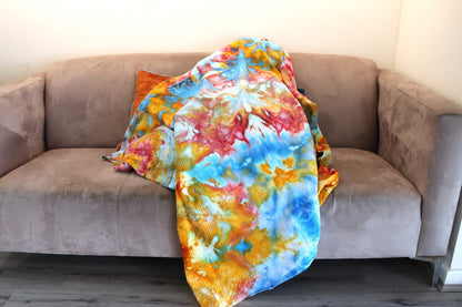 Photo of blue, yellow and red ice-dyed cotton throw