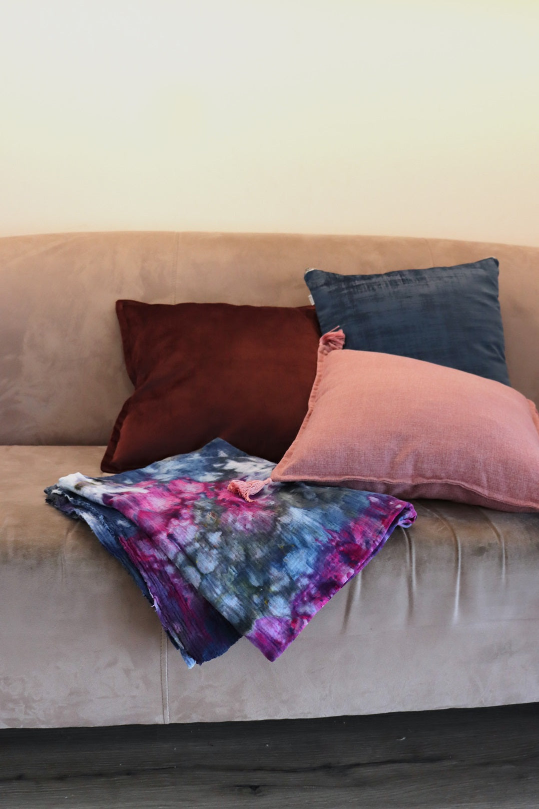 Folded ice-dyed cotton throw on couch