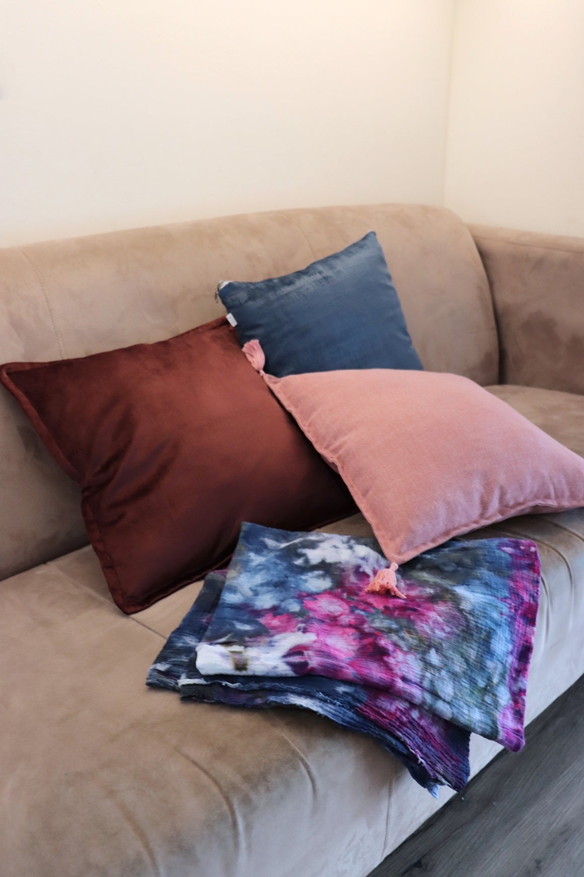 Lifestyle photo of handmade cushion cover with tassels on couch