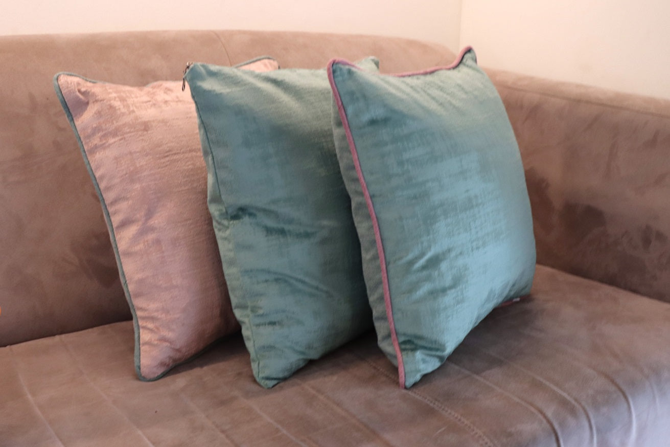 Lifestyle photo of high quality velvet cushion cover with contrasting piping on couch