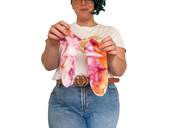 Person holding ankle length purple and orange Ice-dyed bamboo socks