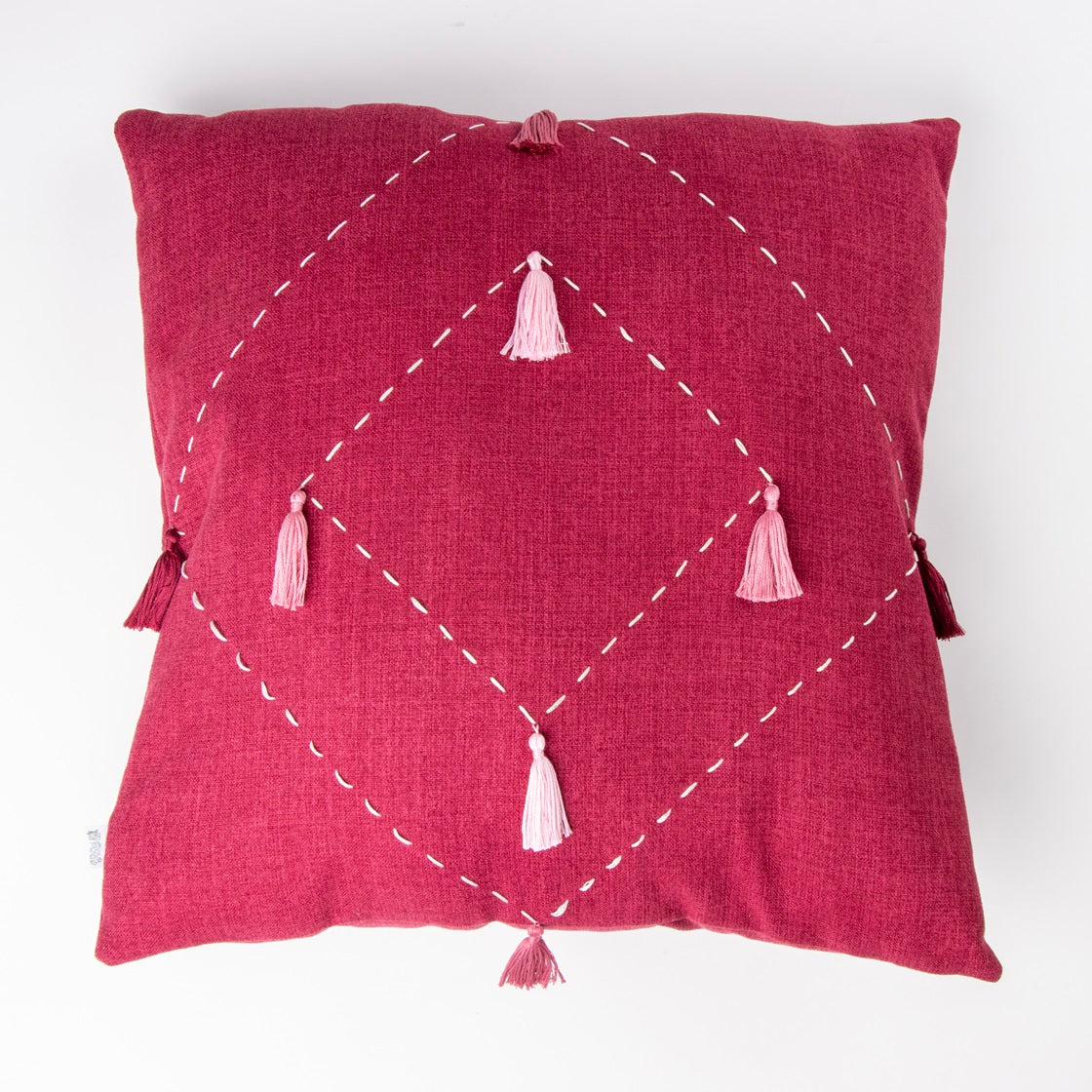 Front of pink diamond cushion cover with embroidery and tassels