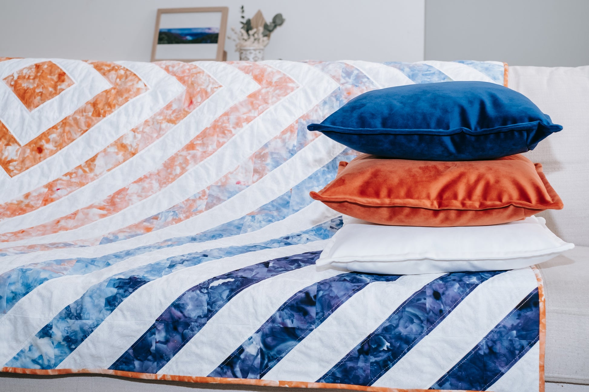 Lifestyle photo of quilt and cushion bundle on sofa