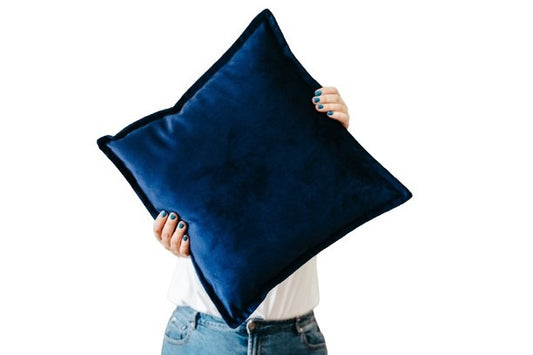 Person holding dark blue velvet cushion cover with flange edging