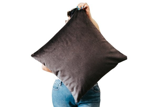 Person holding steel grey textured velvet cushion cover