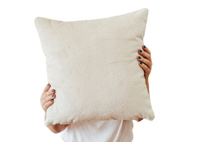 Person holding white textured velvet cushion cover