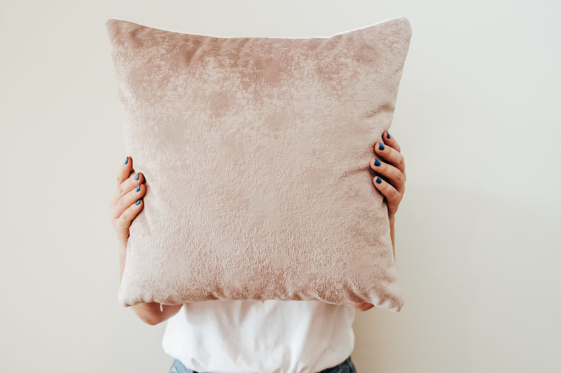 Close up of person holding textured velvet cushion cover