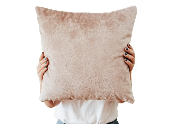 Person holding textured velvet cushion cover