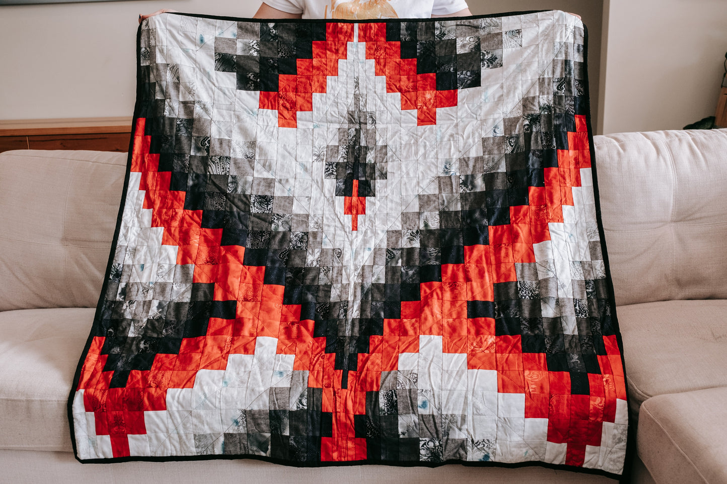 Bargello quilt from quilt and cushion bundle being held up