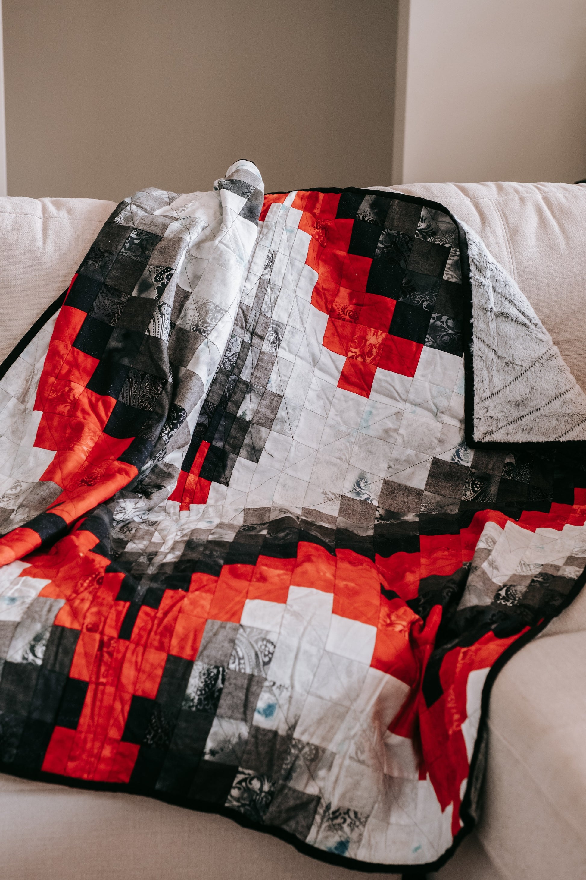 handmade bargello quilt with mink backing on couch