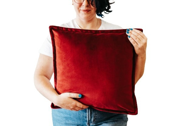 Person holding passion red velvet cushion cover with flange edging