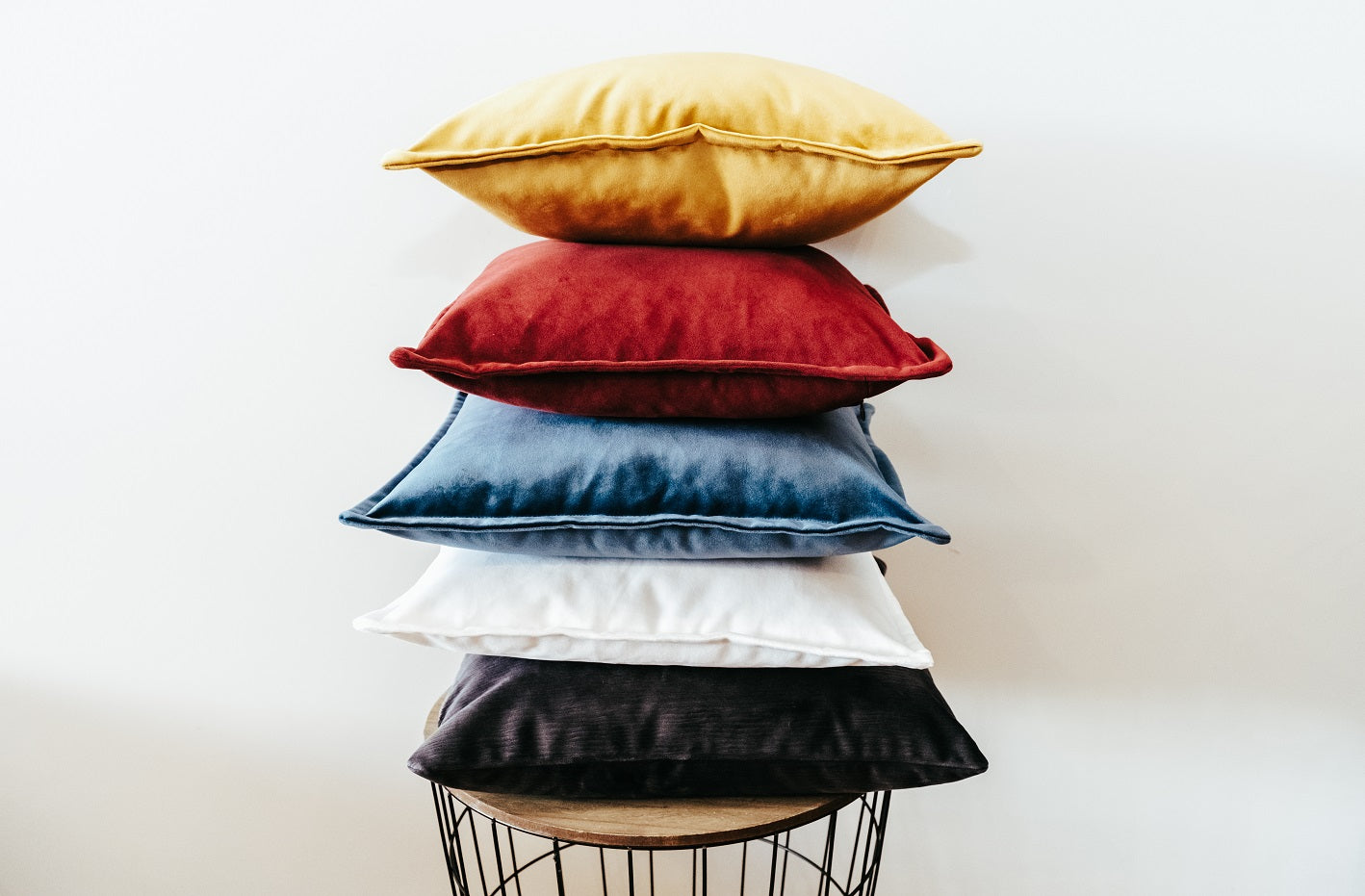 Stack of velvet cushion cover with flange edging