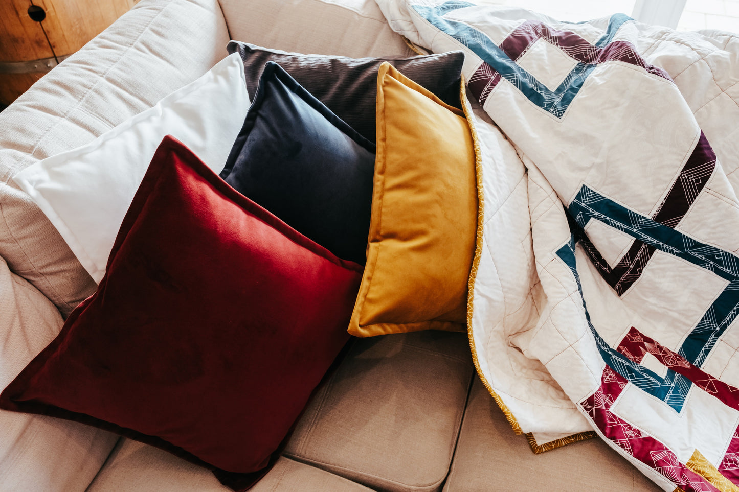 Velvet cushions and handmade quilt with mink backing on sofa