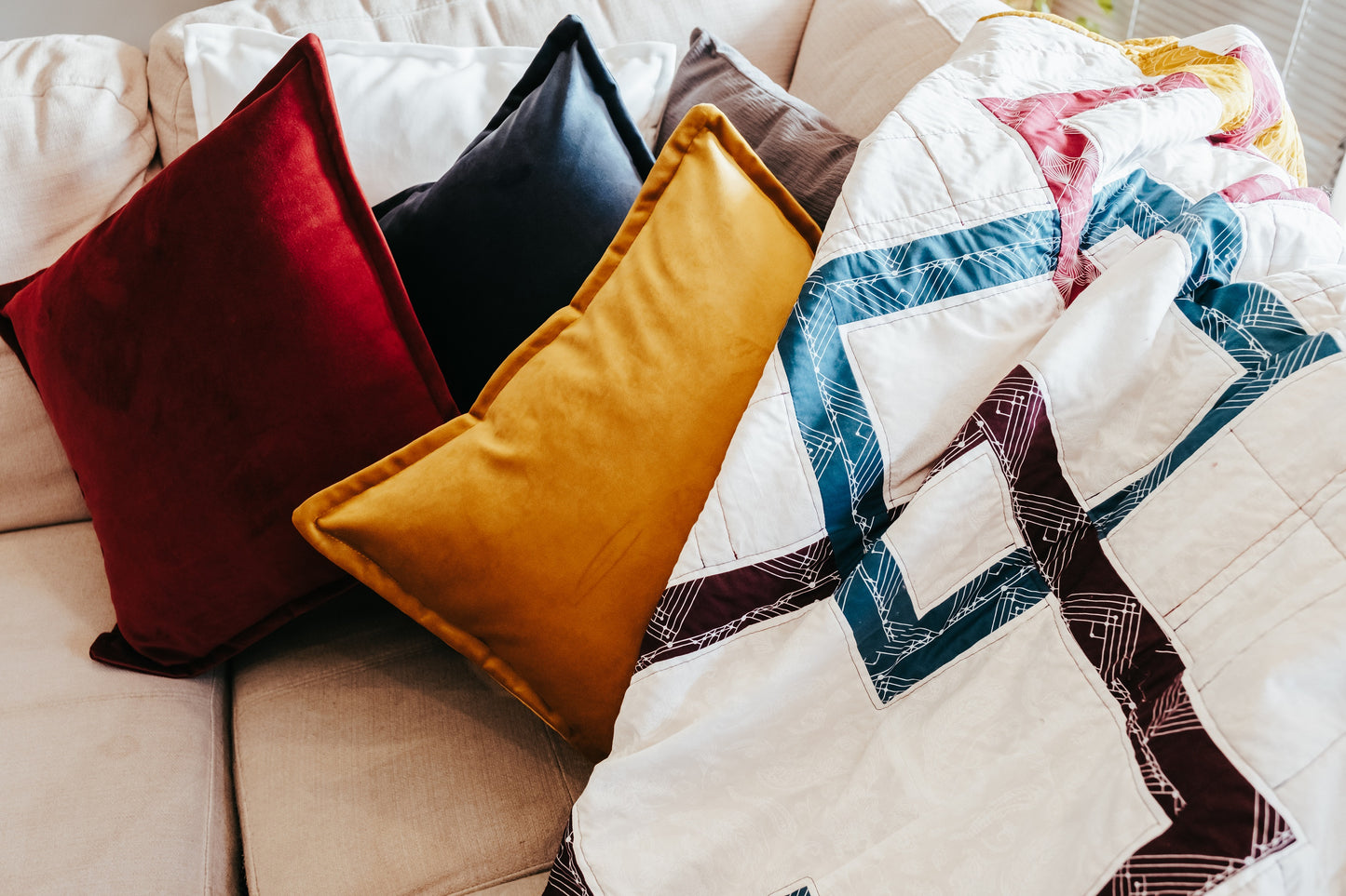 Velvet cushions and handmade quilt with mink backing on couch