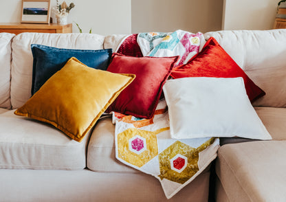 Lifestyle photo of velvet cushion cover with flange edging on sofa