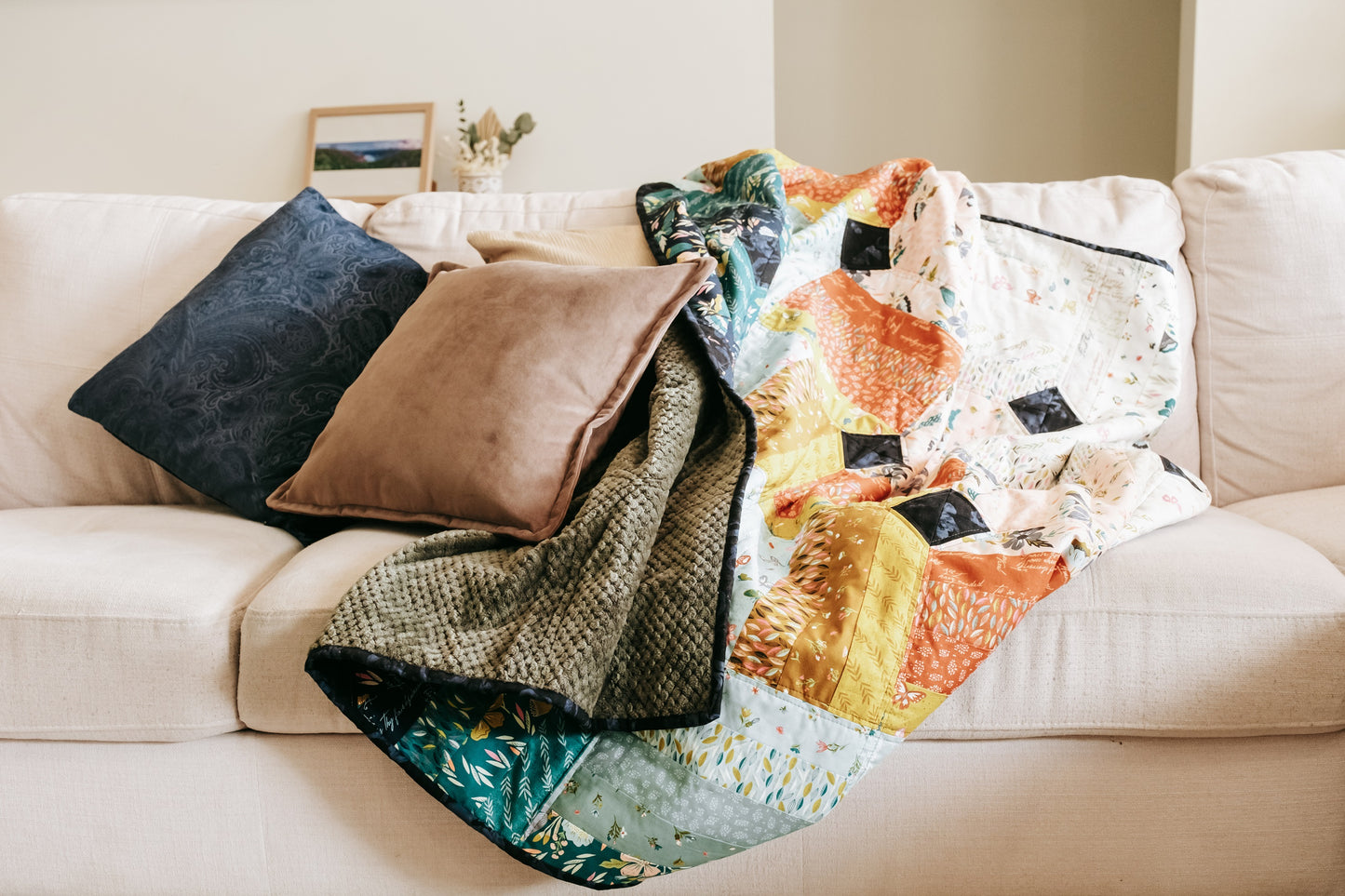 Lifestyle photo of handmade quilt with mink backing on couch