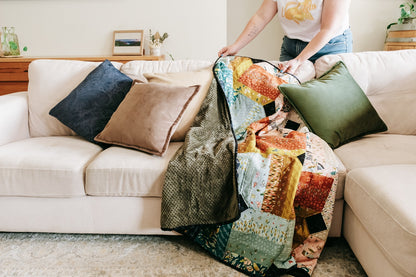 Lifestyle photo of handmade quilt with mink backing on sofa