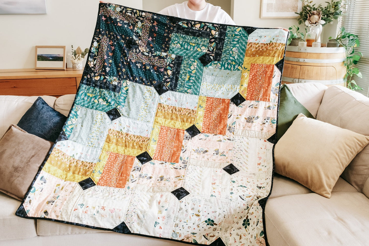 Photo of handmade quilt and cushion bundle on sofa