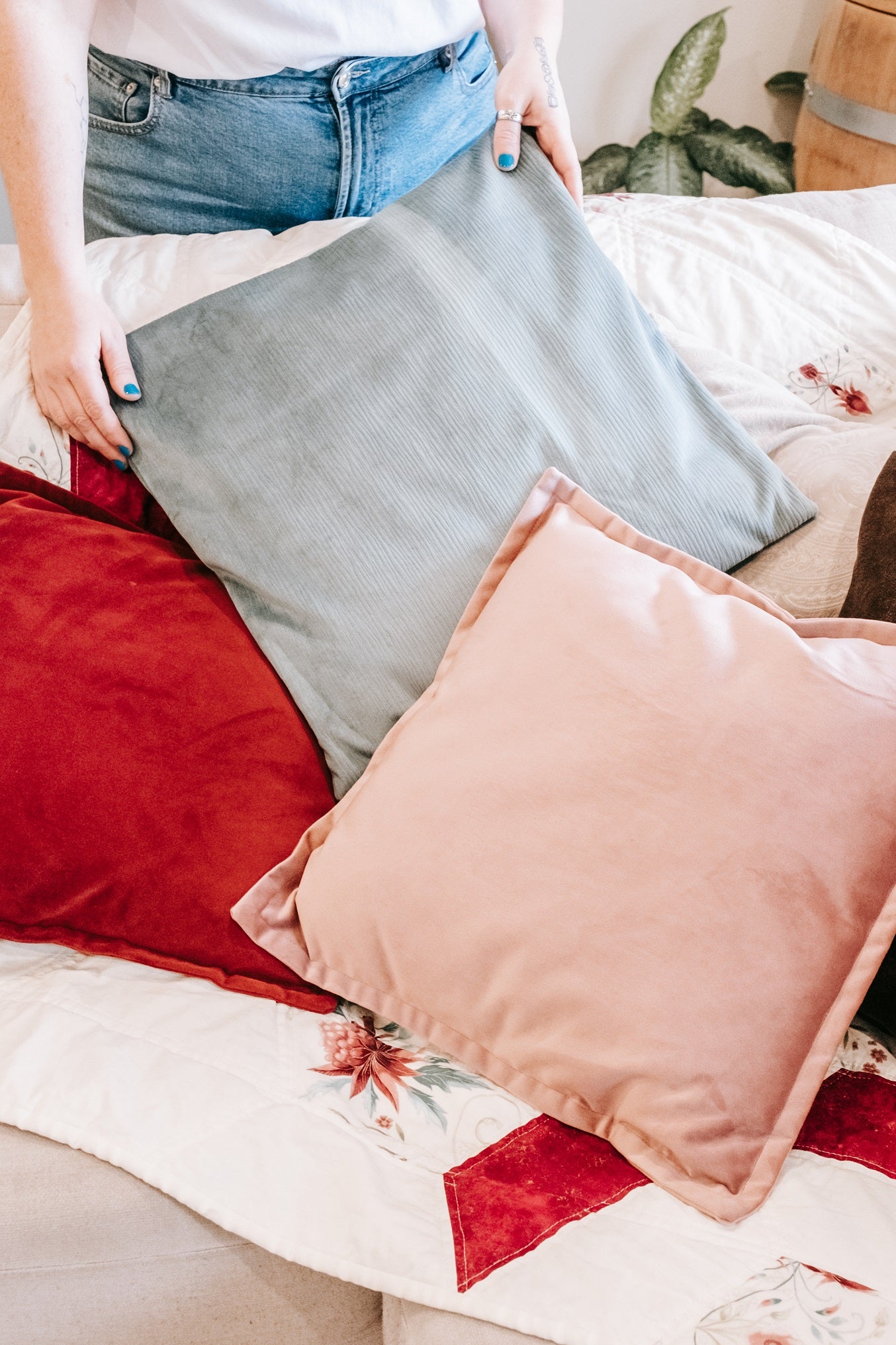 Lifestyle photo of handmade quilt with mink backing and velvet cushions