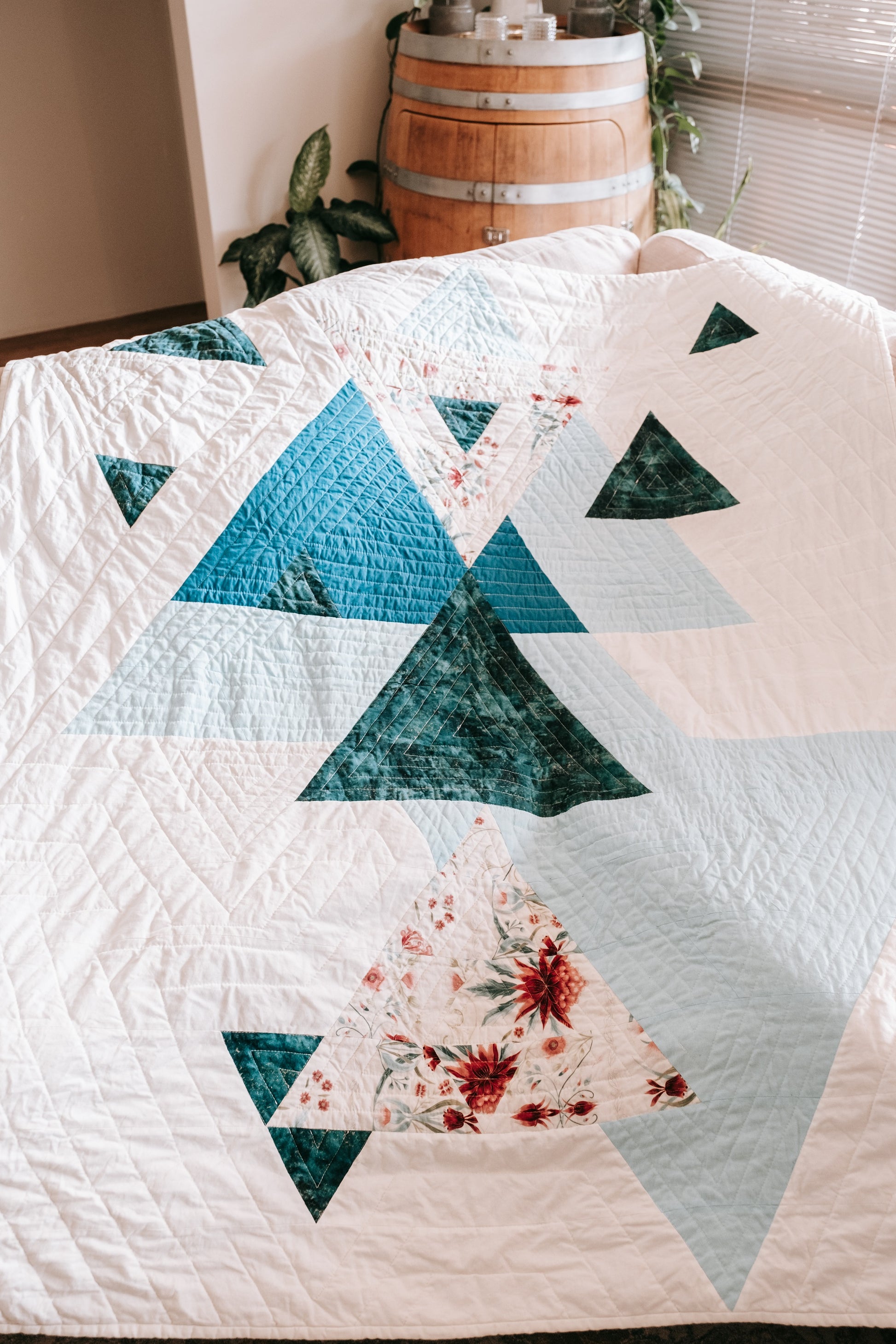 Geometric triangle handmade quilt with mink backing on couch