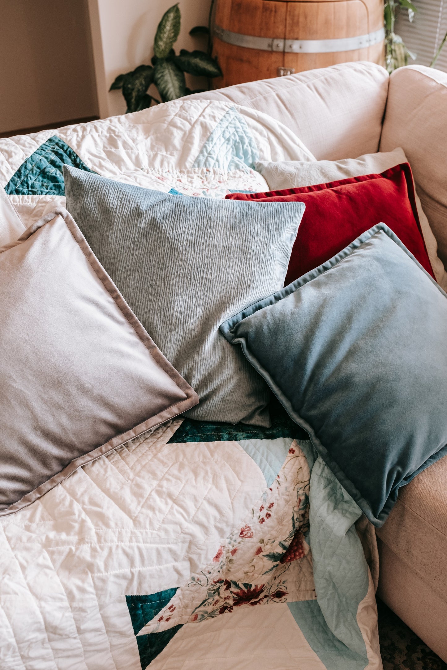 Lifestyle photo of handmade quilt with mink backing with velvet cushions