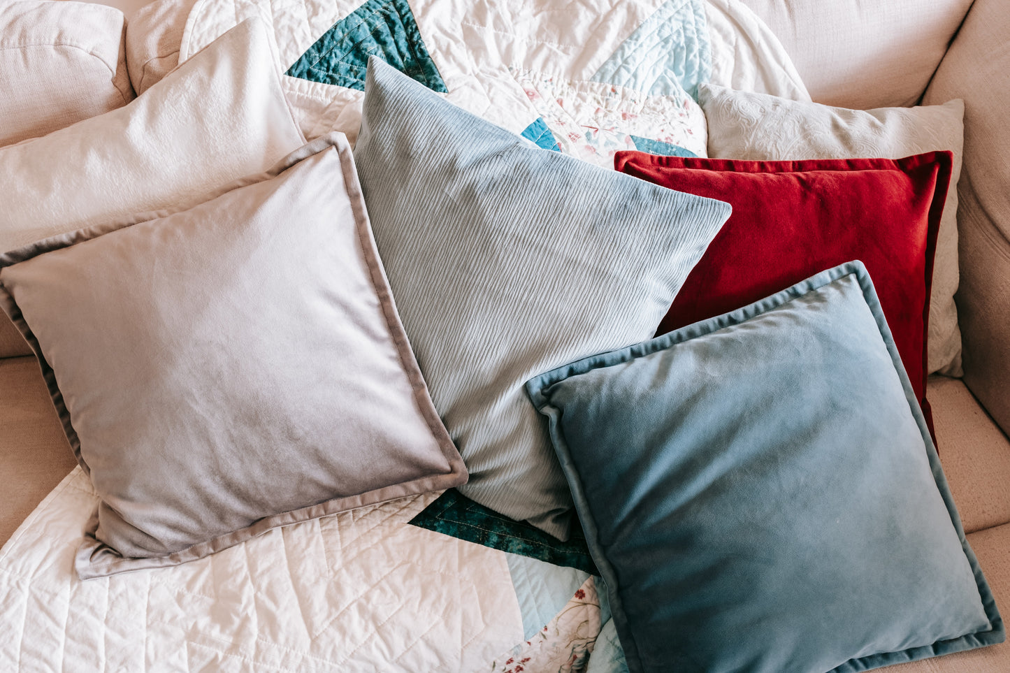 Lifestyle photo of velvet cushion cover with flange edging on sofa